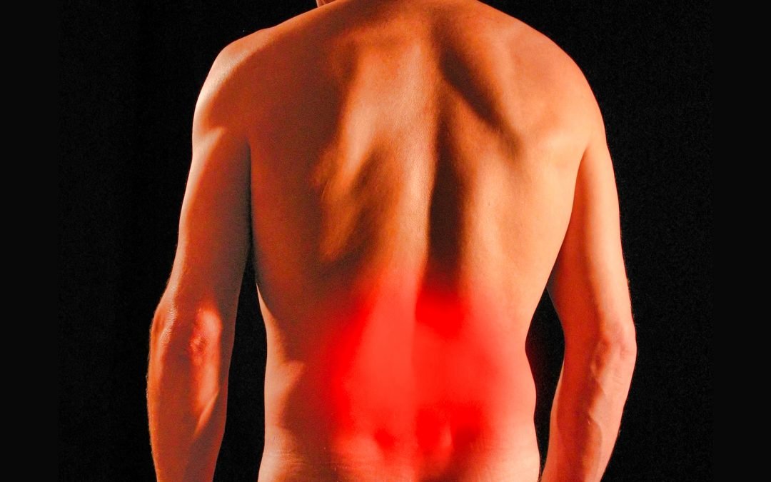 Picture of lowerback of person with a red glow demonstrating pain in that area